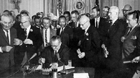 Lyndon Johnson signing Civil Rights 
Act